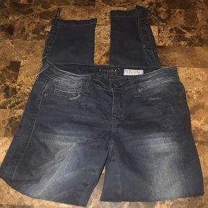 Dark blue jeans with ties at ankles